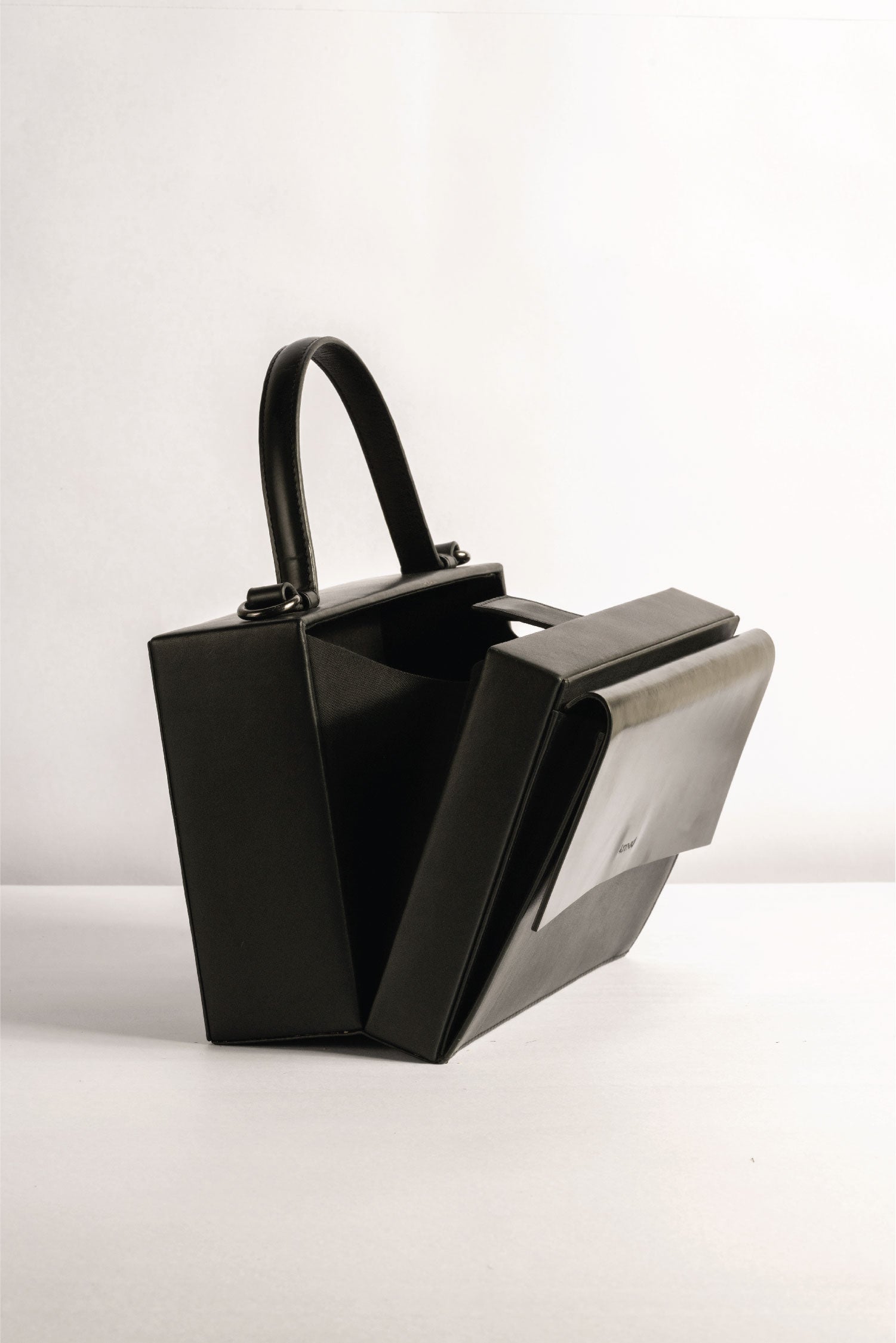 Box Bag leather, Tann-ed, crafted in genuine leather with a top handle and side and crossbody sling