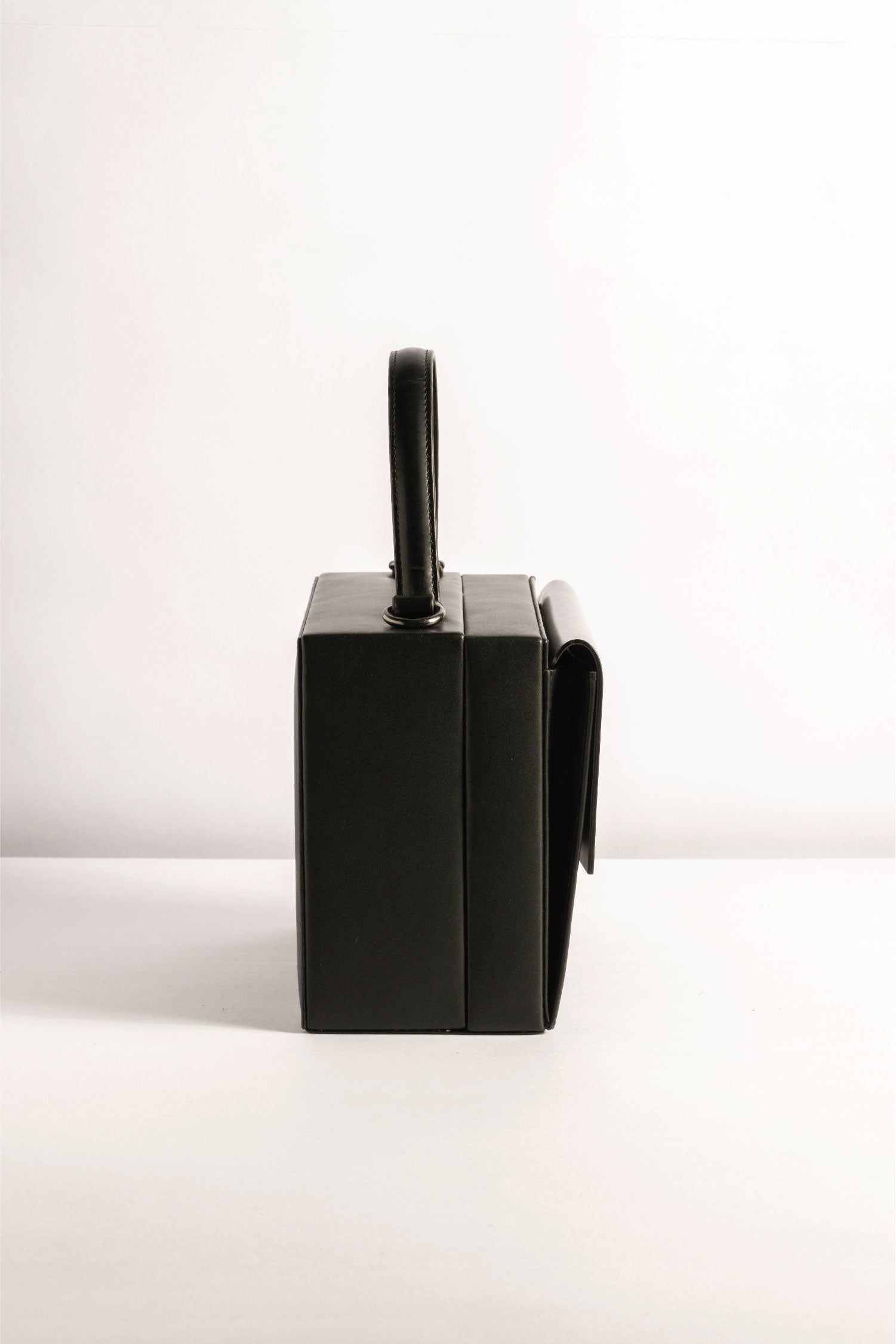 Box Bag leather, Tann-ed, crafted in genuine leather with a top handle and side and crossbody sling